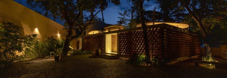 Lake house in India was built around the native palm trees
